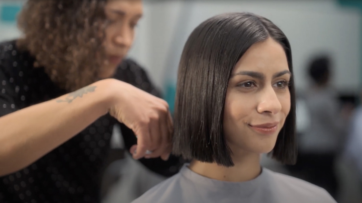 woman getting haircut in great clips salon